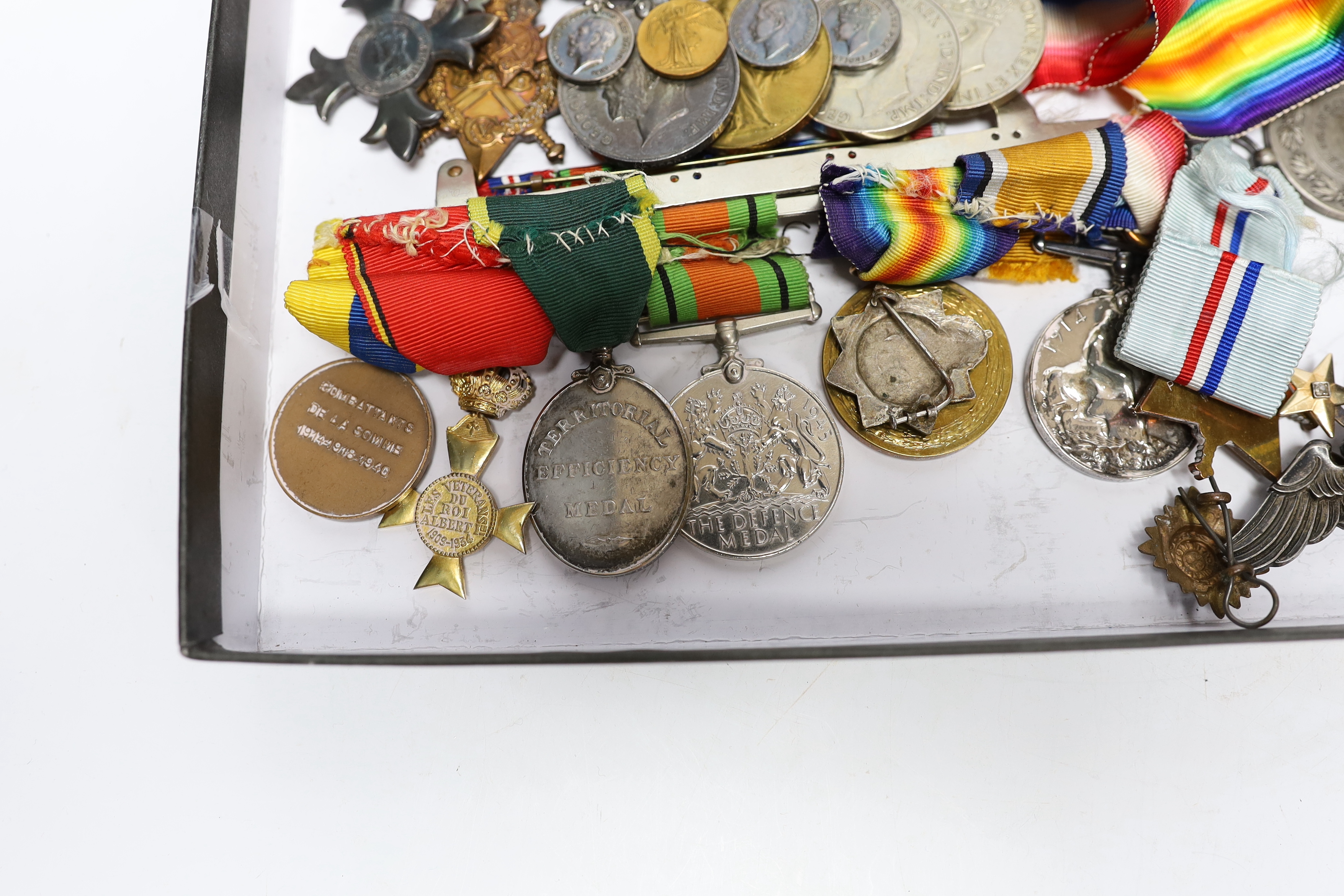 A collection of eighteen medals and some associated miniatures; a WWI/WWII group including a military MBE, WWI trio, WWII Defence and War medals to J.I.B. Farrant R.N. together with its miniature group and bar